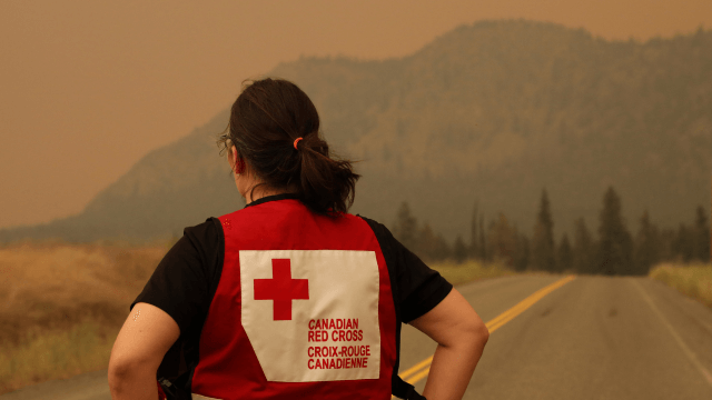 A Canadian Red Cross volunteer watching the fires in Kamloops BC