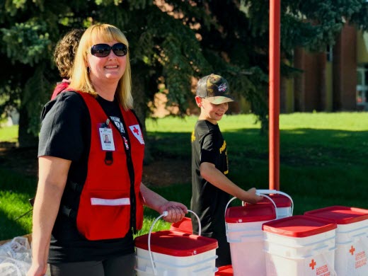 Red Cross staff member Shannon Halpenny delivers clean up kits
