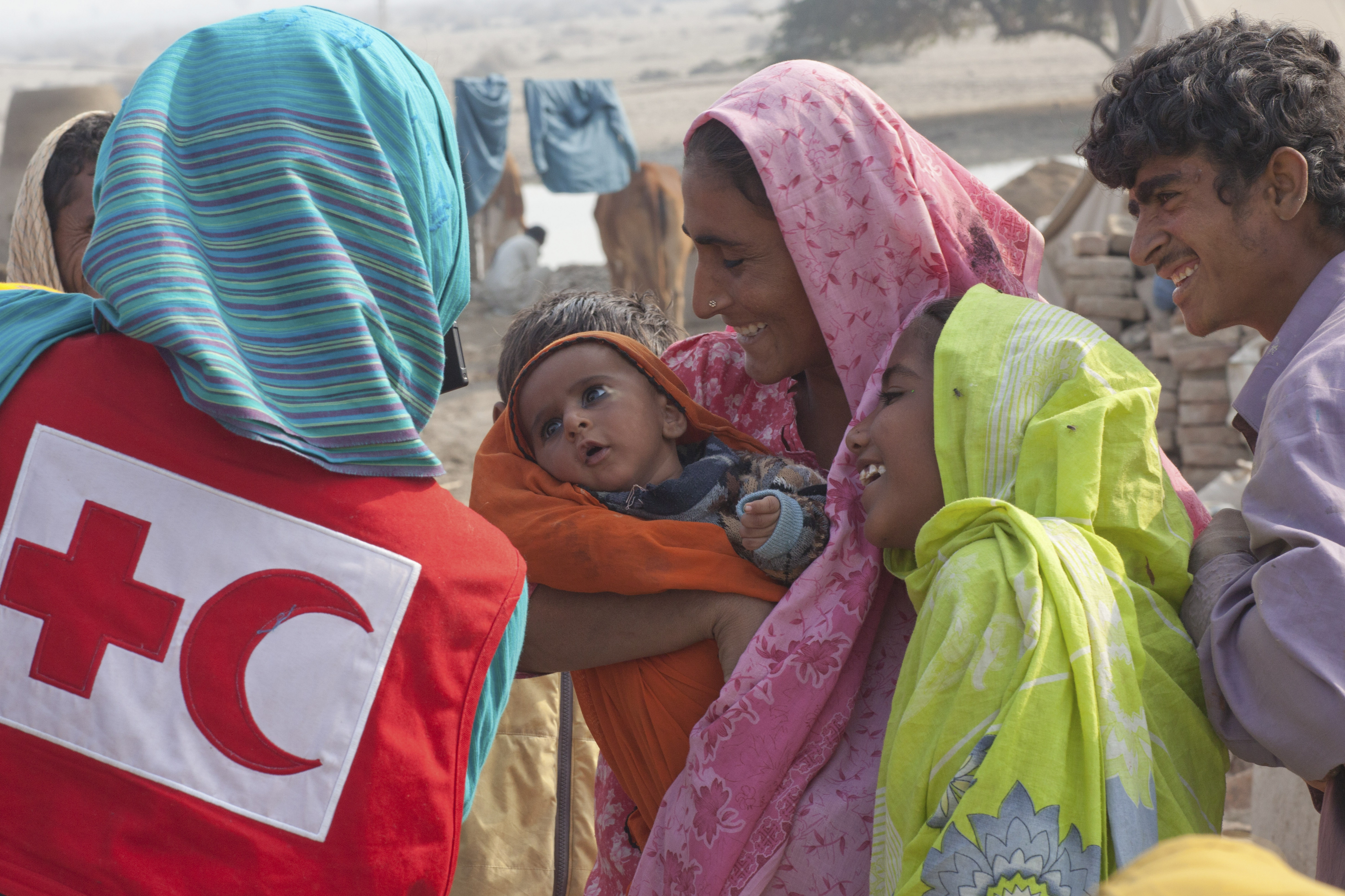 woman holding kid in rural area in Pakistan